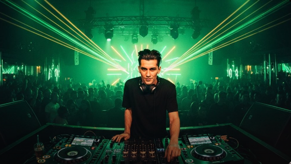 DJ performing at an exclusive nightclub with emerald green and gold lights